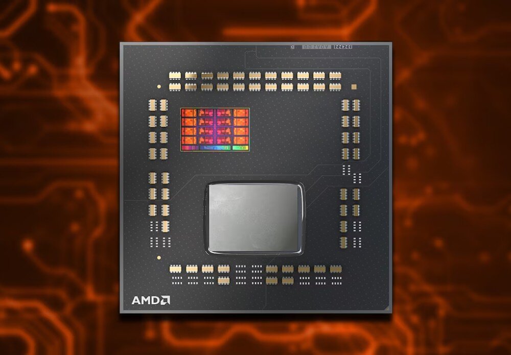 Procesor AMD Ryzen 7 7700X3D Procesor w przybliżeniu bez metalowej osłony. Widoczne dwa prostokątne rdzenie krzemowe na ciemnej płytce z rzędami małych elementów