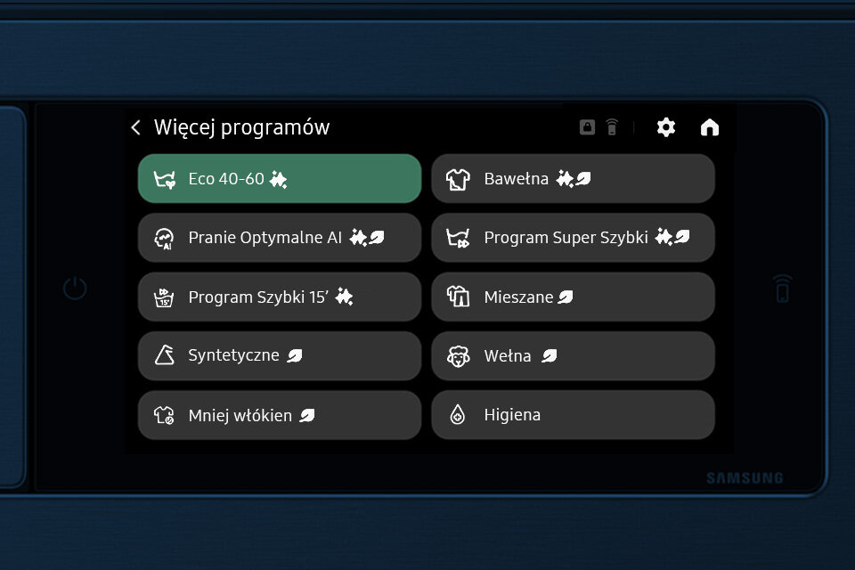 Ekran pralki wyświetla listę programów: Eco 40-60, Pranie Optymalne AI, Program Szybki 15\', Syntetyczne, Mniej włókien, Bawełna, Program Super Szybki, Mieszane, Wełna, Higiena. Logo \'SAMSUNG\' widoczne w prawym dolnym rogu.