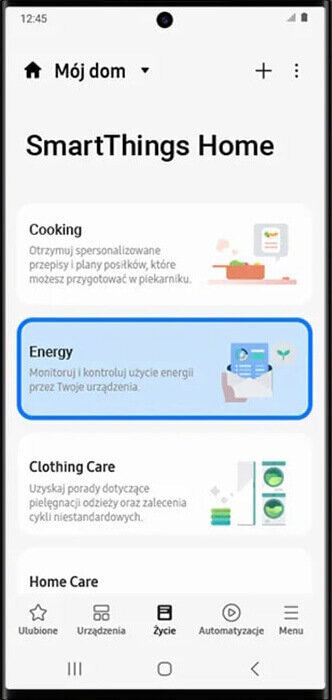 Ekran aplikacji SmartThings Home z trzema sekcjami: Cooking, Energy i Clothing Care. Sekcja Energy jest wyróżniona i zawiera tekst: \'Monitoruj i kontroluj użycie energii przez Twoje urządzenia.\'