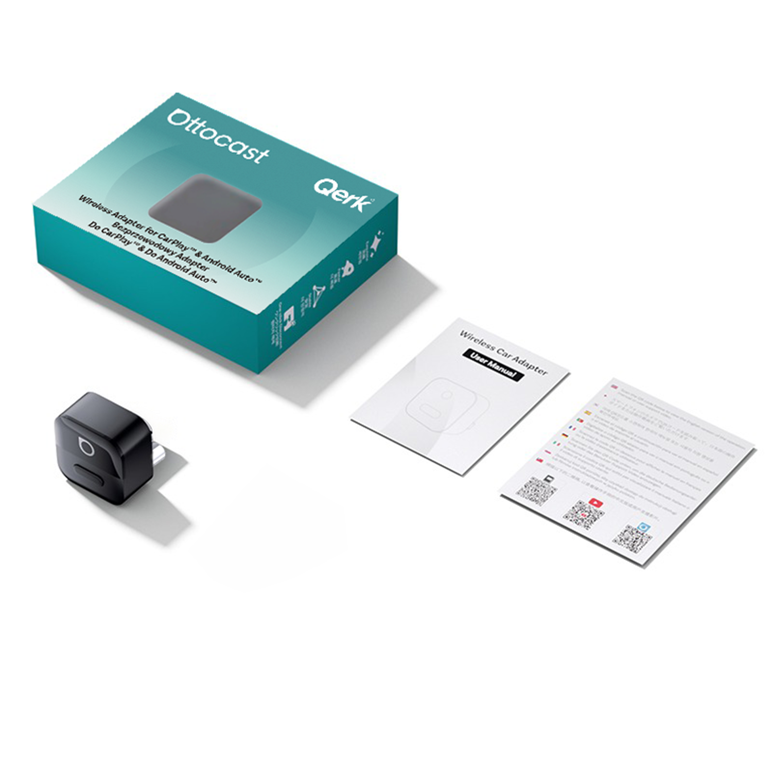 Na obrazie znajduje się pudełko z napisem \'Ottocast Qerk\' oraz \'Wireless Adapter for CarPlay & Android Auto\'. Obok pudełka leży czarny adapter oraz dwie broszury, jedna z napisem \'Wireless Car Adapter User Manual\'.