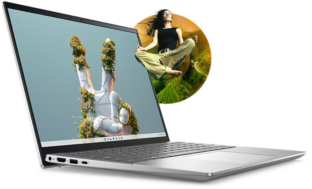 Srebrny laptop z otwartym ekranem, na którym widoczna jest grafika przedstawiająca rękę pokrytą roślinnością. Obok laptopa znajduje się okrągły obrazek z osobą w pozycji medytacyjnej na tle natury.