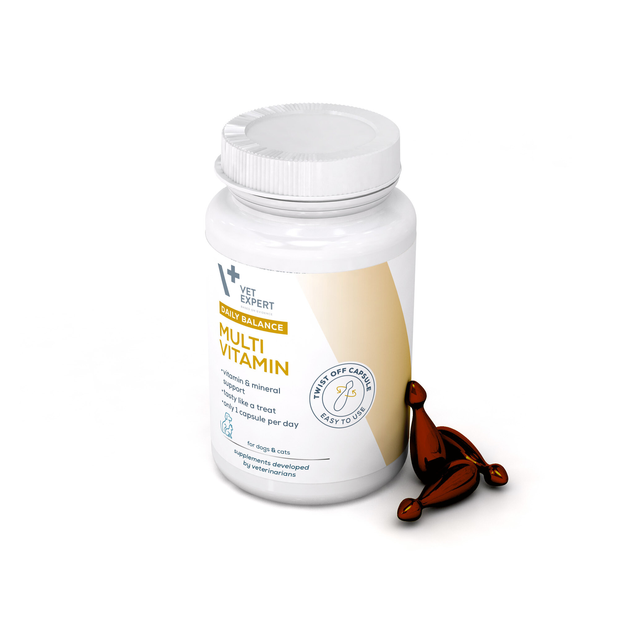 Biały pojemnik z etykietą \'Vet Expert Daily Balance Multi Vitamin Mini\' oraz trzema brązowymi kapsułkami obok. Na etykiecie widnieje napis \'for dogs & cats\' oraz \'supplements developed by veterinarians\'.