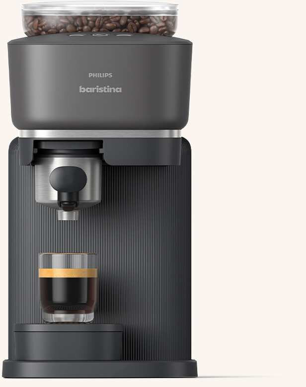 Na obrazie widoczny jest ekspres do kawy z logo \'PHILIPS baristina\', z filiżanką kawy pod dyszą. Na górze urządzenia znajduje się przezroczysty pojemnik z ziarnami kawy.