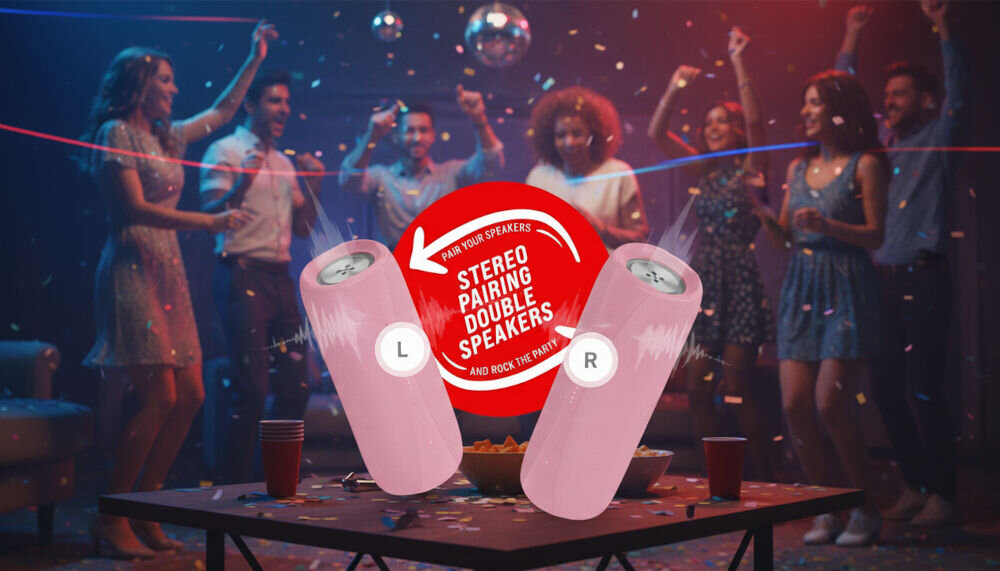 Na pierwszym planie znajdują się dwa różowe głośniki z oznaczeniami \'L\' i \'R\', a pomiędzy nimi czerwone koło z napisem \'PAIR YOUR SPEAKERS STEREO PAIRING DOUBLE SPEAKERS AND ROCK THE PARTY\'. W tle widać grupę ludzi tańczących na imprezie, a na stole leżą konfetti i czerwone kubki.