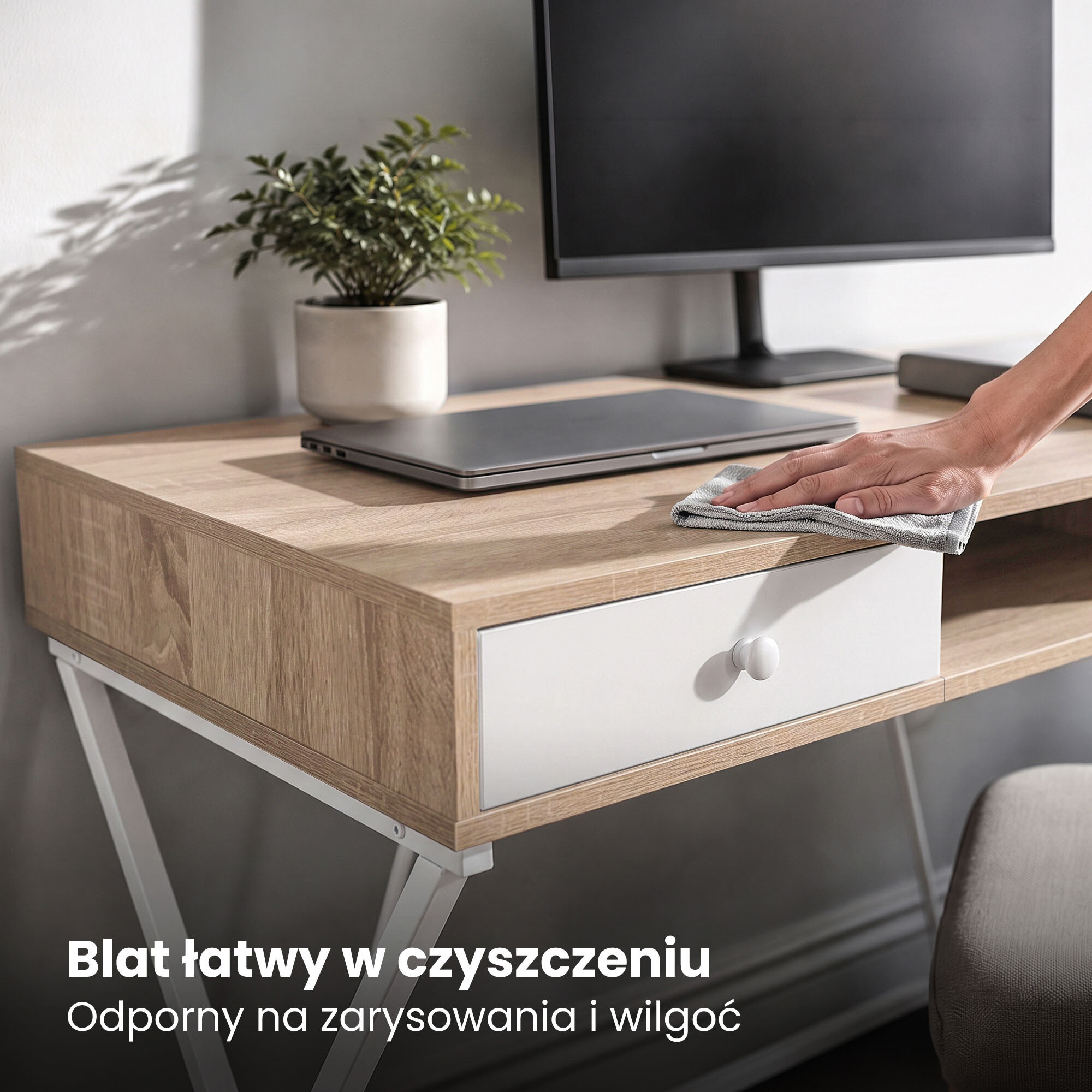 Biurko z blatem w kolorze dębu Sonoma, z białymi nogami i szufladą, na którym stoi laptop i monitor. Tekst na obrazie: \'Blat łatwy w czyszczeniu Odporny na zarysowania i wilgoć\'.