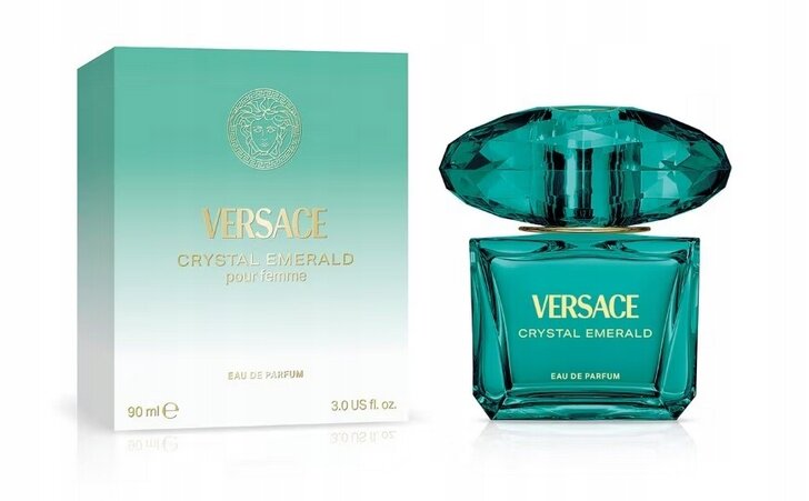 Na obrazie widoczny jest flakon perfum w kolorze szmaragdowym oraz pudełko z napisem \'VERSACE CRYSTAL EMERALD pour femme\'. Na pudełku znajduje się również logo producenta i informacje \'EAU DE PARFUM\', \'90 ml\', \'3.0 US fl. oz.\'.