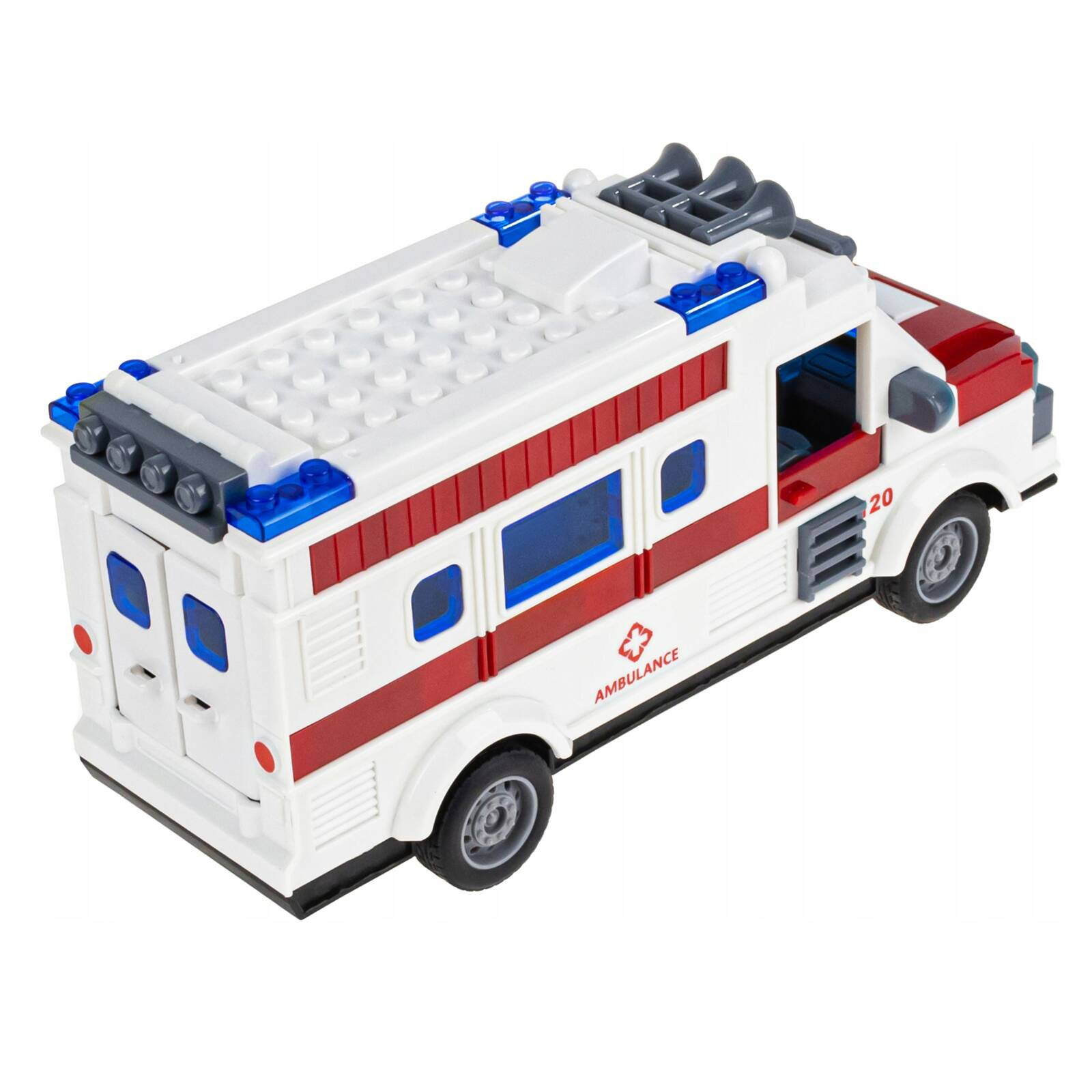 Zabawka w kształcie karetki pogotowia z białymi i czerwonymi elementami oraz niebieskimi oknami. Na boku widoczny jest napis \'AMBULANCE\'.