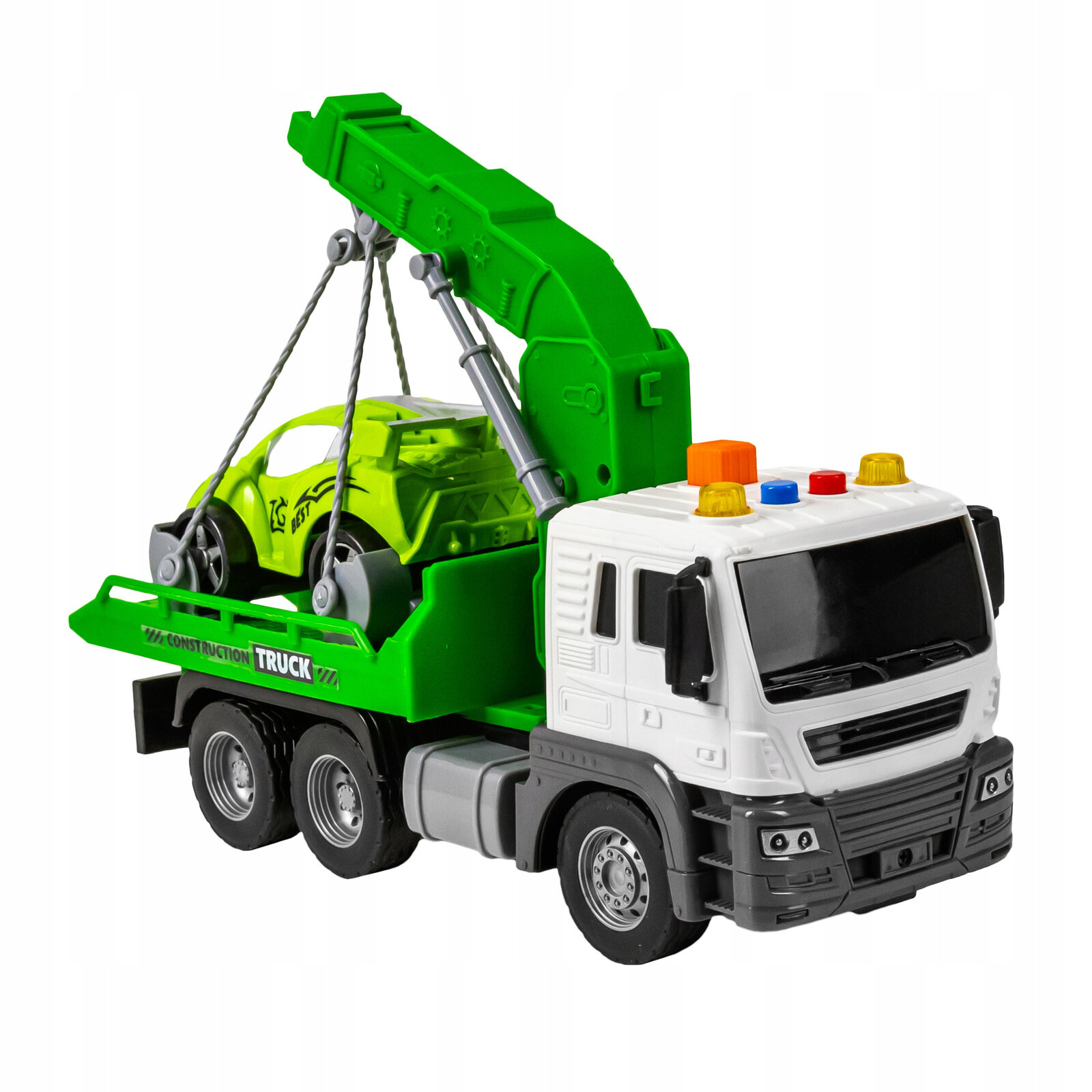 Zabawka holownik z białą kabiną i zieloną naczepą, na której znajduje się zielone autko. Na naczepie widoczny jest napis \'CONSTRUCTION TRUCK\'.