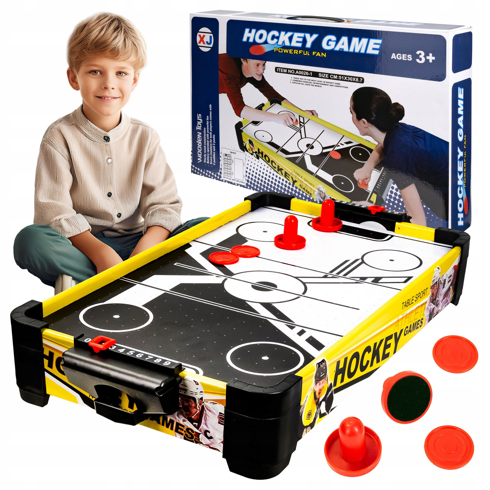 Na obrazie widoczny jest stół do gry cymbergaj z systemem air flow, z czerwonymi elementami do gry. W tle znajduje się pudełko z napisem \'HOCKEY GAME\' oraz informacją \'AGES 3+\'.
