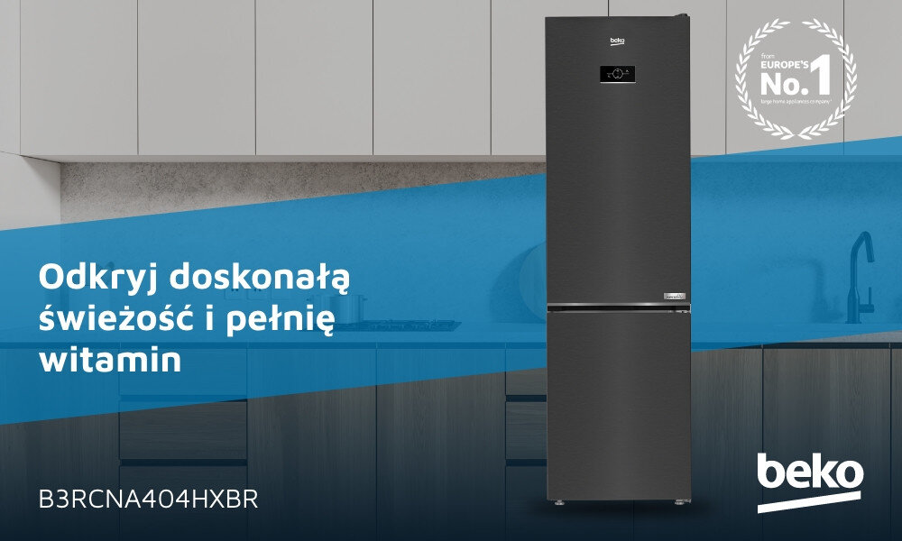 Na obrazie znajduje się ciemnoszara lodówka z wyświetlaczem, umieszczona w nowoczesnej kuchni. Widoczny jest tekst: \'Odkryj doskonałą świeżość i pełnię witamin\', \'B3RCNA404HXBR\', oraz logo \'beko\'.