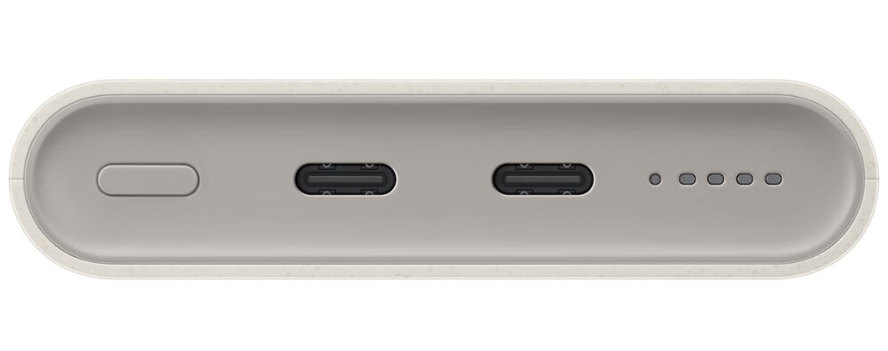 Obraz przedstawia beżowy powerbank z dwoma portami USB-C, przyciskiem oraz czterema diodami LED wskazującymi poziom naładowania.