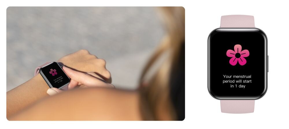 Na zdjęciu widać smartwatch z różowym paskiem, na którego ekranie wyświetla się różowy kwiat oraz tekst: \'Your menstrual period will start in 1 day\'.