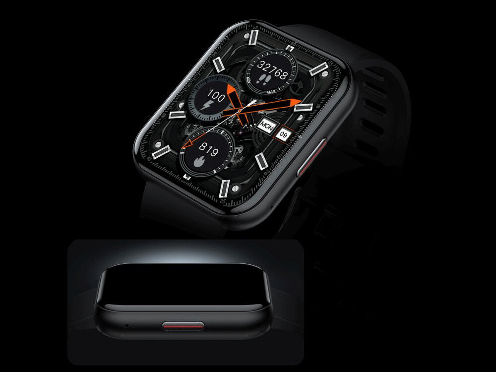 Czarny smartwatch z prostokątną tarczą, na której widoczne są trzy okrągłe wskaźniki z cyframi: 32768, 100 i 819 oraz datownik z dniem tygodnia \'MON\' i dniem miesiąca \'09\'. W dolnej części obrazu znajduje się zbliżenie na bok urządzenia z widocznym przyciskiem.