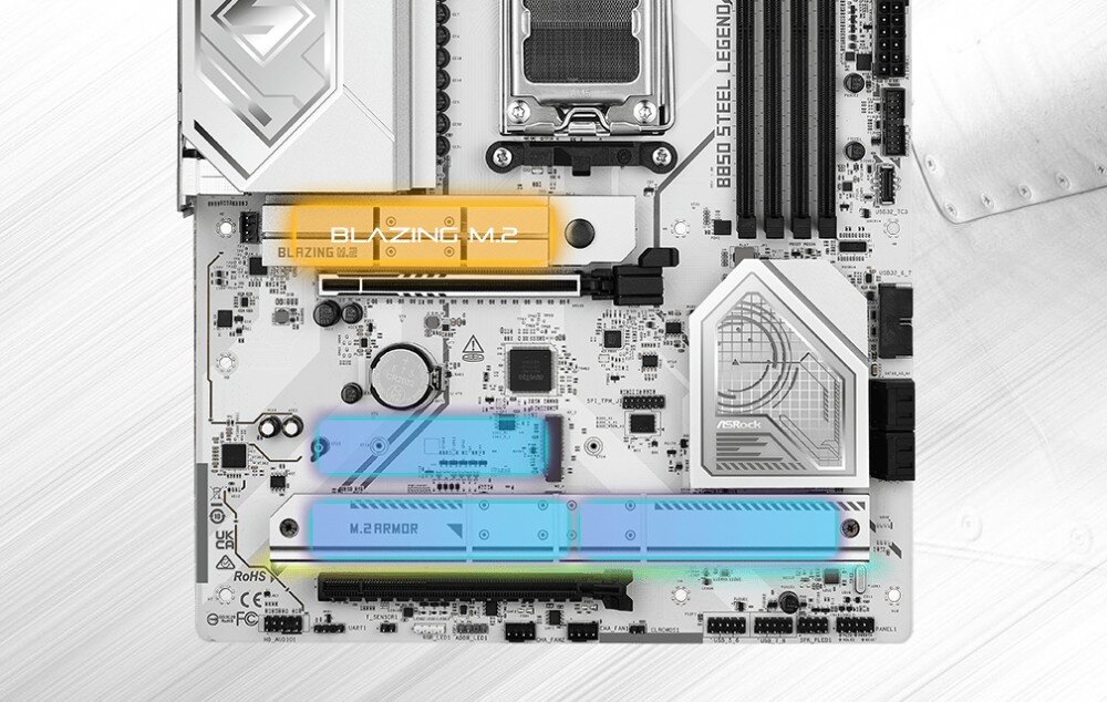 Obraz przedstawia płytę główną z oznaczeniami \'BLAZING M.2\' i \'M.2 ARMOR\'. Widoczne są różne komponenty elektroniczne oraz logo ASRock.
