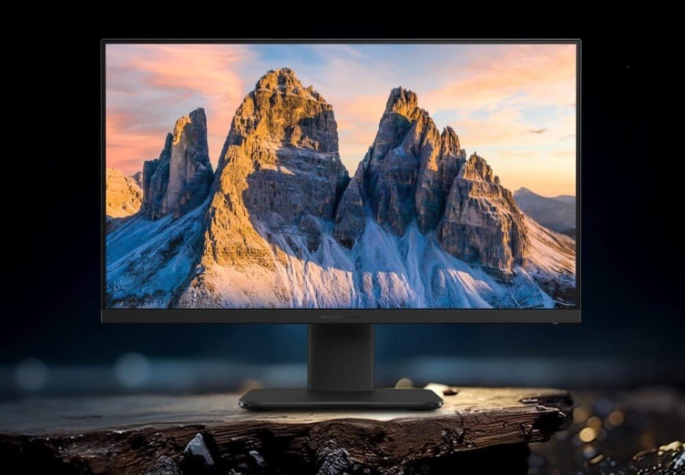 Komputer All in One ASUS V440VAT-BPD036W Czarny komputer stacjonarny wyświetlający tapetę ze skalistymi szczytami górskimi o zachodzie słońca, umieszczony na ciemnym tle, konstrukcja, wielkość, system, wytrzymałość
