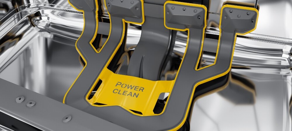 Wnętrze zmywarki z widocznym elementem w kolorze szarym i żółtym z napisem \'POWER CLEAN\'.