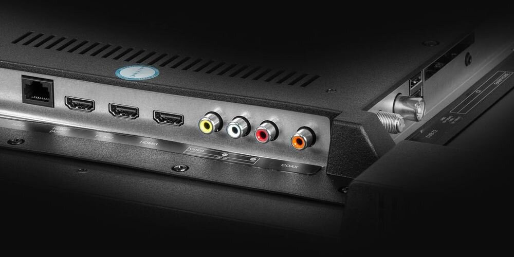 Zdjęcie przedstawia tylny panel telewizora z widocznymi portami HDMI, portem Ethernet oraz kolorowymi wejściami audio-wideo. Obok znajdują się oznaczenia portów i złącze antenowe.
