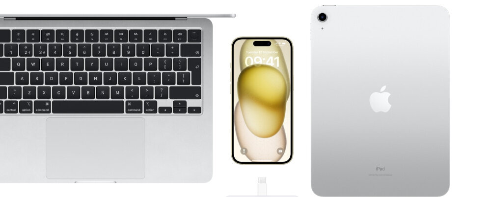 Na zdjęciu widoczny jest laptop z klawiaturą, smartfon z wyświetlaczem pokazującym godzinę 09:41 oraz tablet z logo jabłka. Pod smartfonem znajduje się kabel z końcówką USB-C.