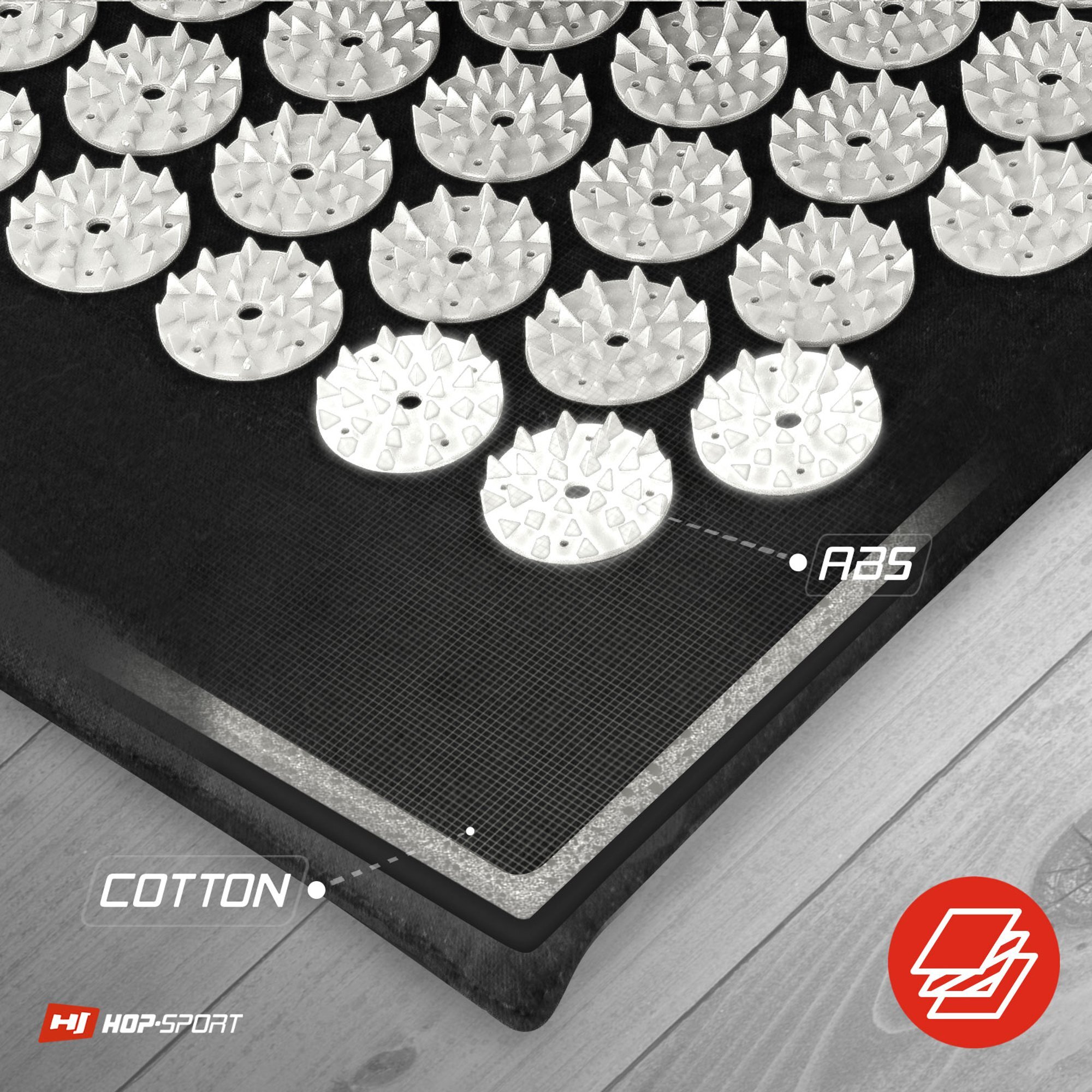 Obraz przedstawia szarą matę do akupresury z białymi kolcami w kształcie okręgów. Widoczny jest tekst: \'COTTON\', \'A35\' oraz logo \'HOP-SPORT\'.