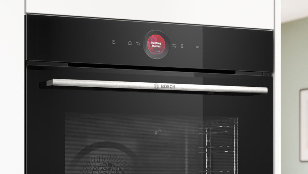 Czarny piekarnik z panelem dotykowym i wyświetlaczem pokazującym \'Heating Modes\'. Na drzwiach znajduje się srebrny uchwyt z logo \'BOSCH\'.