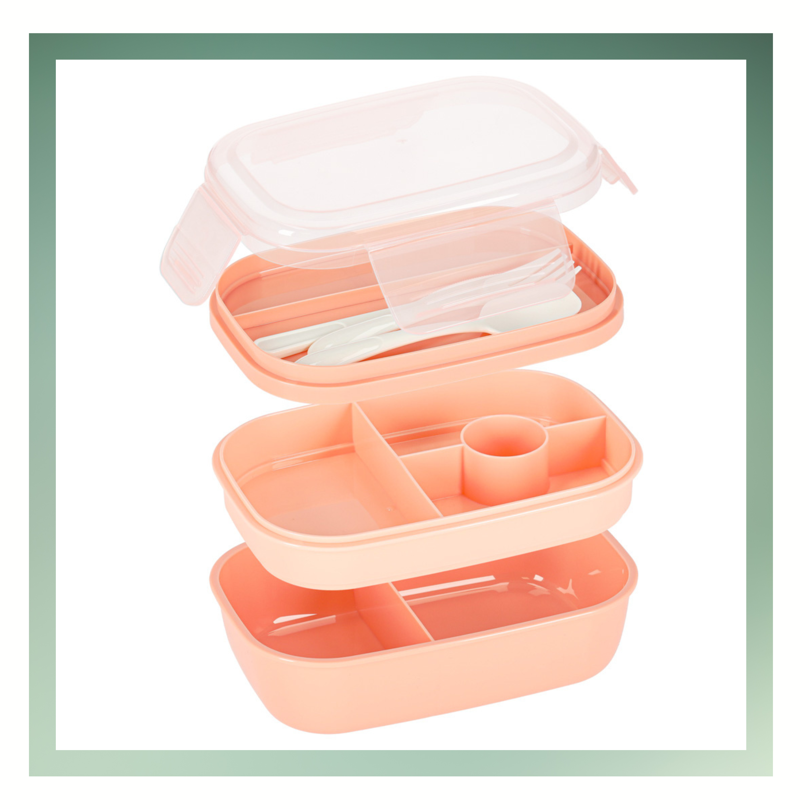 Na obrazie widoczny jest różowy lunchbox z przegródkami i przezroczystą pokrywką. W środku znajdują się sztućce, a pudełko ma kilka komór na jedzenie.