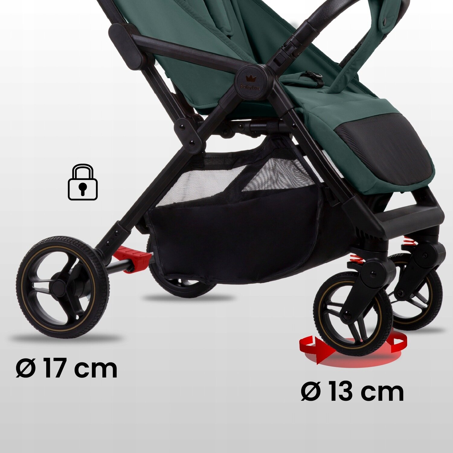 Obraz przedstawia dolną część wózka spacerowego z czterema kołami, z czego dwa przednie są obrotowe. Widoczne są oznaczenia średnicy kół: 17 cm i 13 cm oraz ikona kłódki.