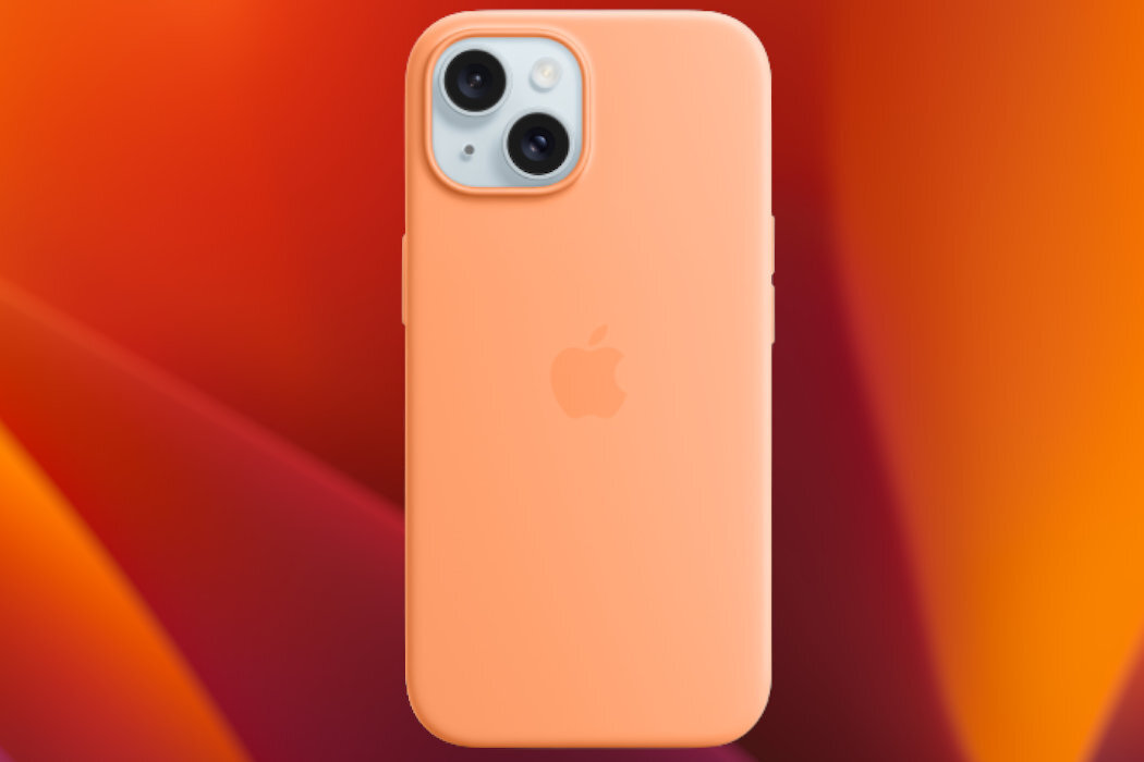 Pomarańczowe etui na telefon z logo Apple, widoczne na tle gradientu w odcieniach pomarańczowego i czerwonego. Etui posiada wycięcia na dwa obiektywy aparatu.