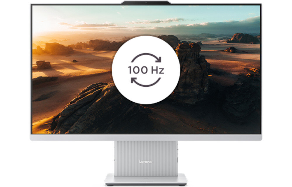 Komputer All in One z dużym ekranem wyświetlającym krajobraz pustynny, na środku widoczny symbol z napisem \'100 Hz\'. Na podstawie monitora znajduje się logo \'Lenovo\'.