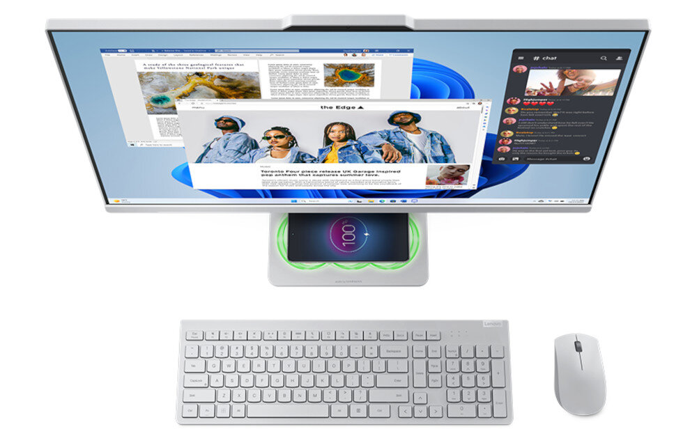 Na obrazie widoczny jest komputer All in One z dużym monitorem, klawiaturą i myszką. Na ekranie wyświetlane są różne aplikacje, w tym przeglądarka internetowa i komunikator.