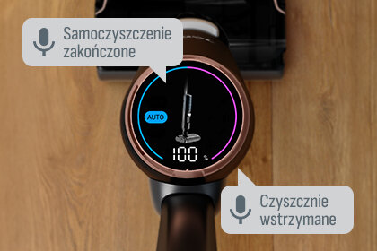Na wyświetlaczu odkurzacza widoczny jest napis \'AUTO\' oraz liczba \'100\'. Obok znajdują się komunikaty: \'Samoczyszczenie zakończone\' i \'Czyszczenie wstrzymane\'.