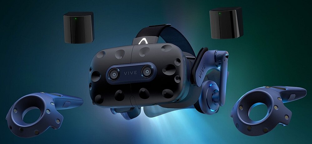 Na obrazie widoczne są gogle VR z napisem \'VIVE\', dwa kontrolery oraz dwa czarne czujniki. Wszystkie elementy mają nowoczesny design i są w ciemnych kolorach.