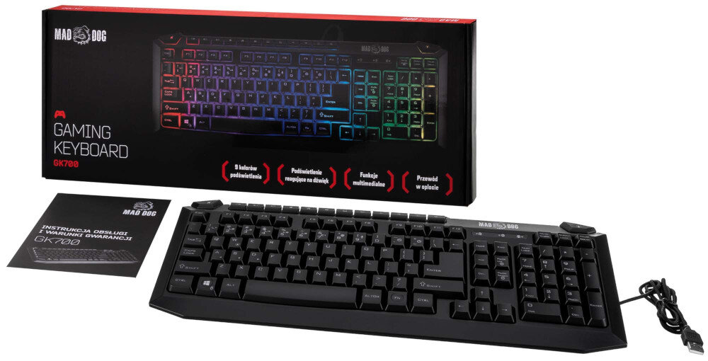 Na obrazie znajduje się klawiatura z podświetleniem RGB oraz pudełko z napisem \'MAD DOG GAMING KEYBOARD GK700\'. Obok klawiatury leży instrukcja obsługi i kabel USB.