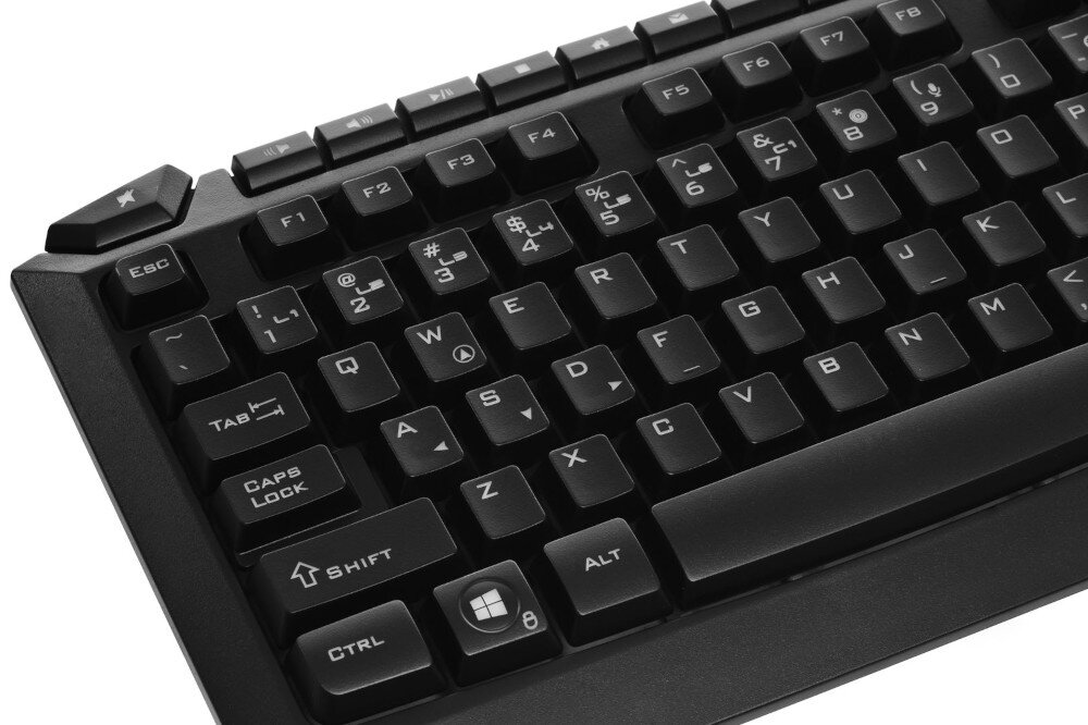 Czarna klawiatura z widocznymi klawiszami, w tym ESC, F1-F12, QWERTY oraz klawisze funkcyjne takie jak CTRL, ALT i SHIFT. Na klawiszu Windows widoczny jest symbol okna.