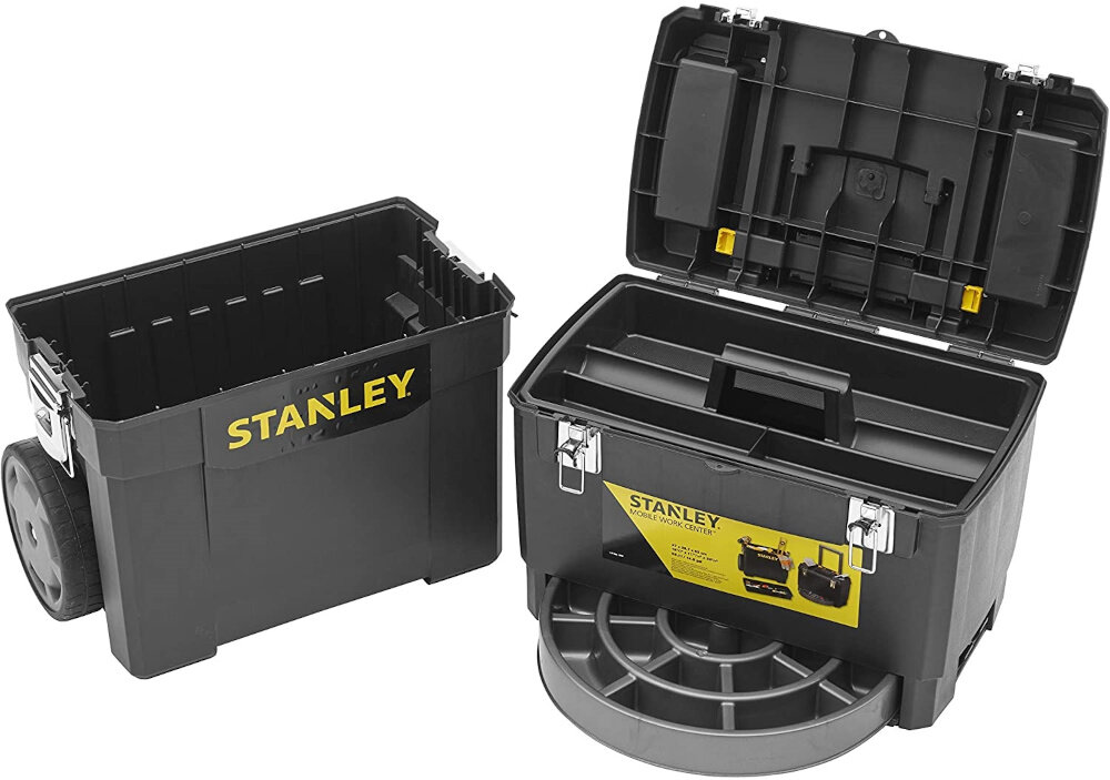 Na obrazie widoczna jest czarna skrzynka narzędziowa z logo \'STANLEY\' w kolorze żółtym. Skrzynka ma otwarte wieko, ukazując wnętrze z przegródkami i metalowymi zapięciami.