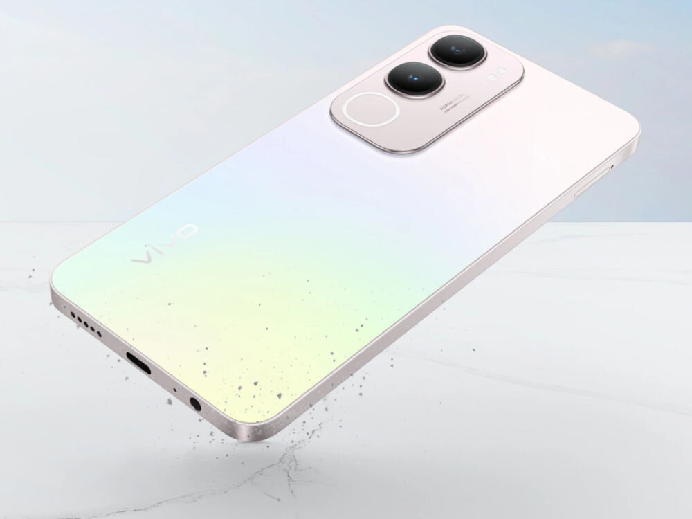 Na obrazie widoczny jest srebrny smartfon z dwoma dużymi obiektywami aparatu na tylnej obudowie. Na obudowie znajduje się logo \'Vivo\'.