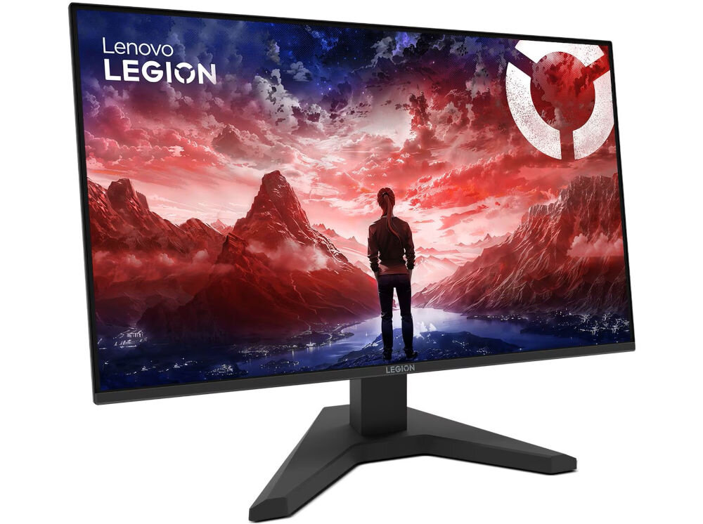 Monitor z logo \'Lenovo LEGION\' wyświetla grafikę przedstawiającą osobę stojącą przed krajobrazem górskim w czerwono-niebieskiej kolorystyce. Monitor ma nowoczesną podstawę w kształcie litery V.