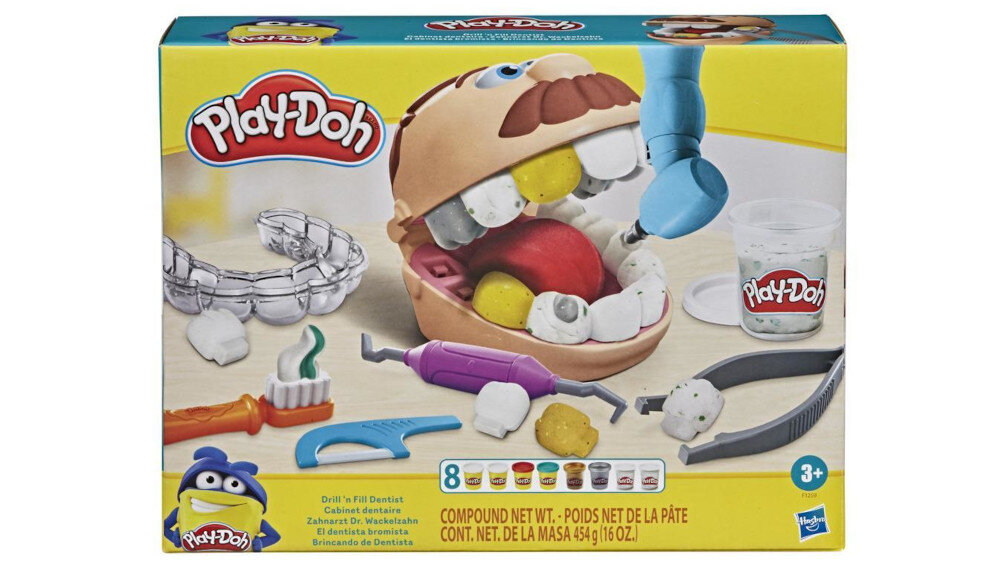 Opakowanie zestawu \'Play-Doh\' przedstawia model głowy z otwartymi ustami, narzędzia dentystyczne i kubek z logo \'Play-Doh\'. Na dole widnieje napis: \'Compound Net Wt. 454 g/16 oz\'.