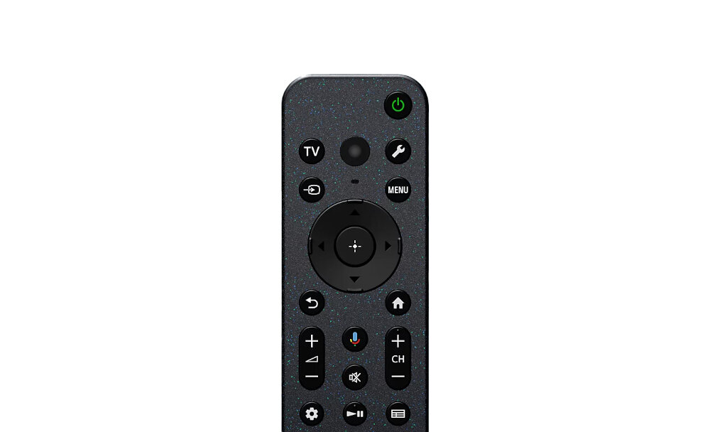 Pilot z ciemnym wykończeniem, posiadający przyciski funkcyjne, w tym przycisk zasilania oznaczony zielonym okręgiem. Widoczne są przyciski takie jak TV, MENU, oraz przyciski nawigacyjne.