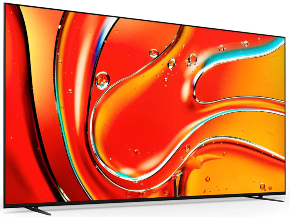 Telewizor z cienką ramką wyświetla abstrakcyjny obraz w intensywnych odcieniach czerwieni i pomarańczu z elementami przypominającymi krople wody. Ekran jest duży i ma nowoczesny design.
