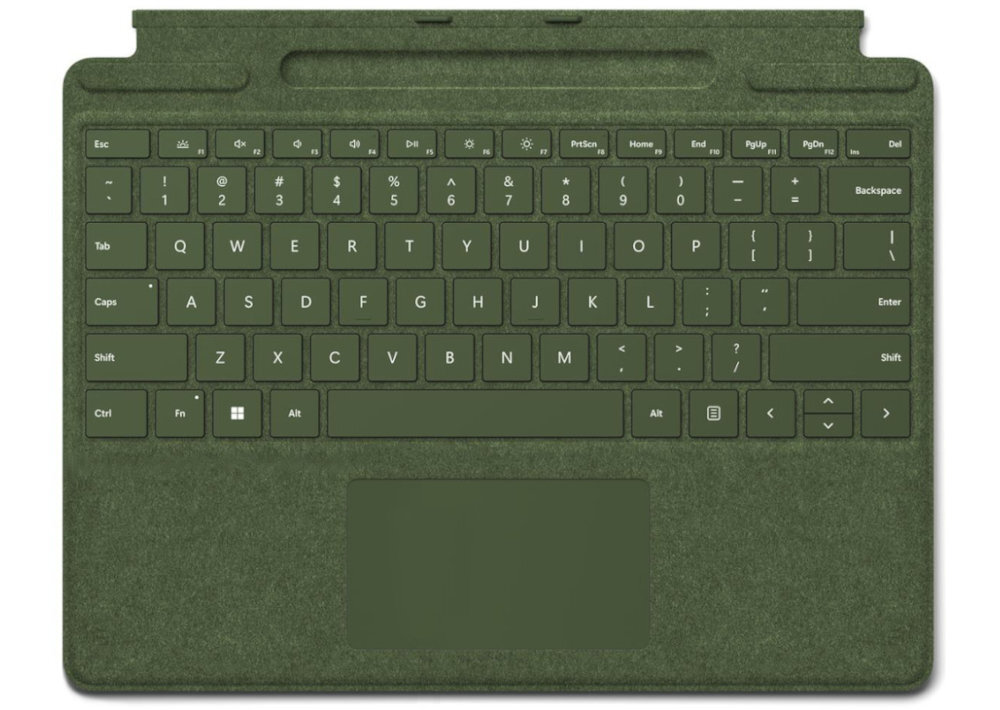 Klawiatura w kolorze zielonym z pełnym układem klawiszy QWERTY oraz touchpadem poniżej. Widoczne są klawisze funkcyjne, strzałki kierunkowe i klawisze numeryczne.