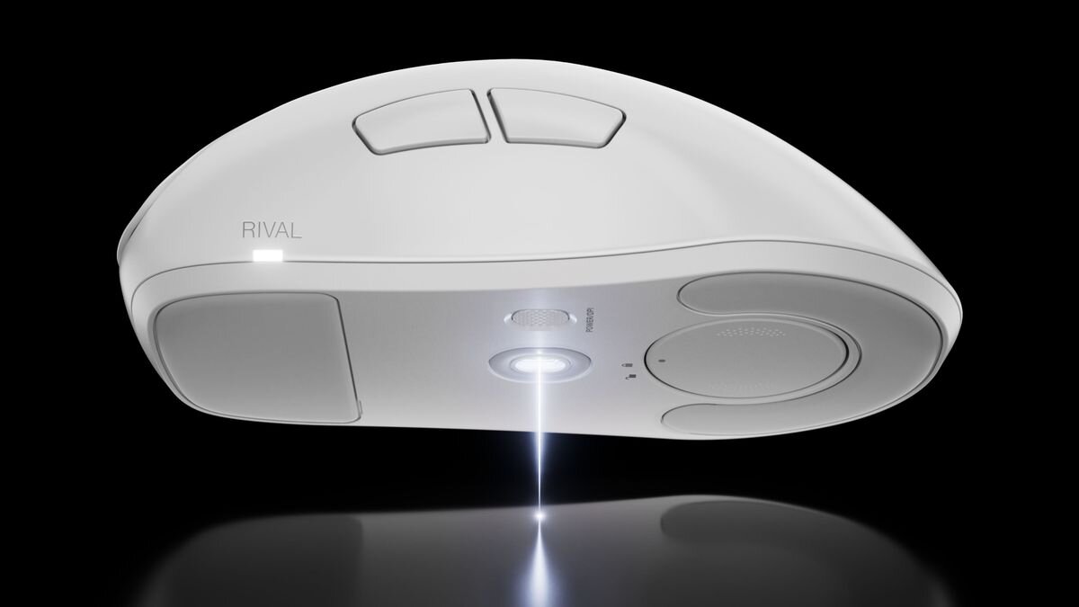 Biała mysz komputerowa z dwoma przyciskami na górze i napisem \'RIVAL\' na boku. Na spodzie widoczny jest sensor optyczny oraz przycisk z napisem \'Bluetooth\'.