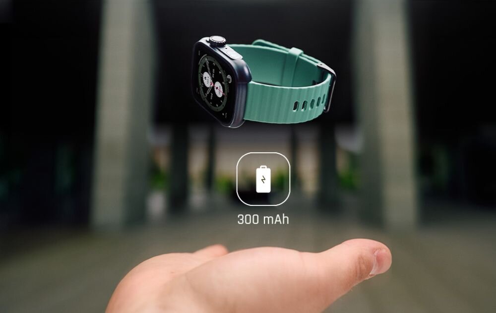 Na obrazie widoczny jest smartwatch z zielonym paskiem unoszący się nad otwartą dłonią. Obok zegarka znajduje się ikona baterii z napisem \'300 mAh\'.