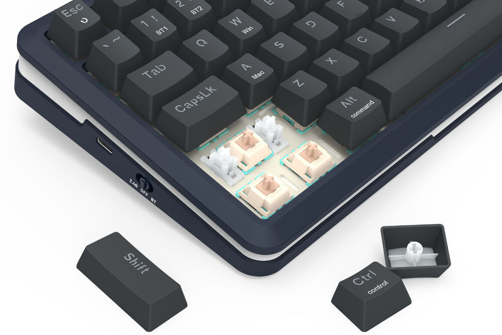 Obraz przedstawia klawiaturę z kilkoma zdjętymi klawiszami, ukazującą mechaniczne przełączniki. Widoczne są klawisze z napisami: \'Shift\', \'Ctrl\', \'CapsLK\', \'Alt\', \'command\', \'control\'.