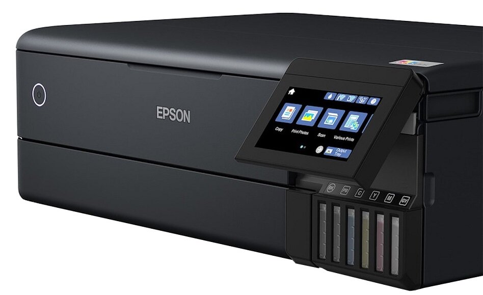 Czarne urządzenie wielofunkcyjne z logo \'EPSON\' na przedniej części. Posiada kolorowy ekran dotykowy z ikonami oraz widoczne pojemniki na tusz.