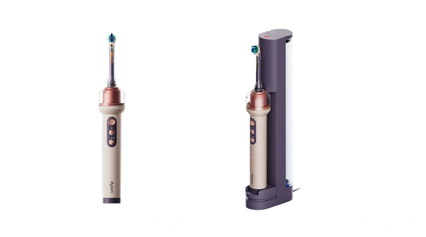 Яскраво-рожева електрична зубна щітка Dyson CameraJet, зображена прямо та під кутом у своїй док-станції.