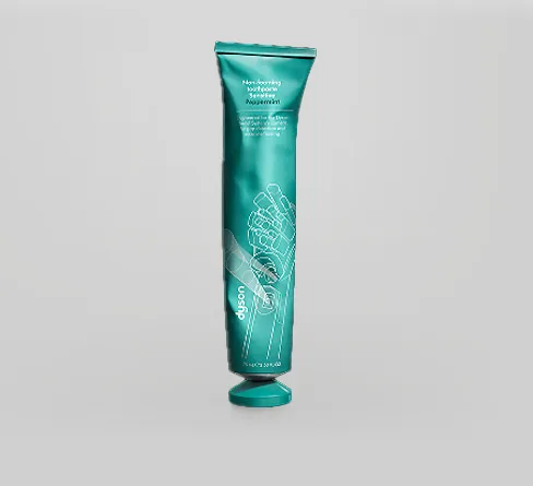 Pasta do zębów Dyson Peppermint w zielonej tubce naturalnie odkształcona od codziennego użytkowania