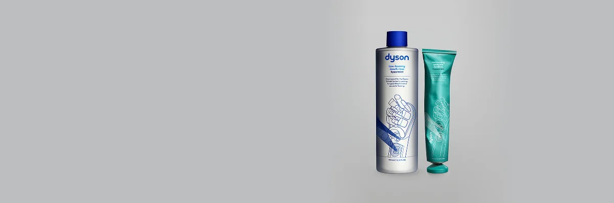 Płyn do płukania jamy ustnej Dyson Spearmint w butelce z niebieską nakrętką i pasta Dyson Peppermint w zielonej tubce
