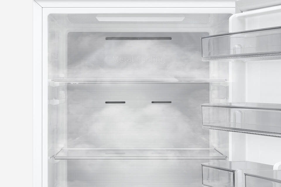 Wnętrze lodówki z widocznymi półkami i szufladami. Na tylnej ściance napis \'Metal Cooling\'.