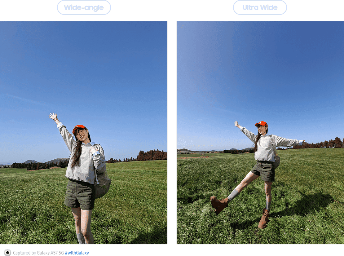 Obraz przedstawia porównanie dwóch zdjęć wykonanych aparatem smartfona, oznaczonych jako \'Wide-angle\' i \'Ultra Wide\'. Na obu zdjęciach widać osobę stojącą na zielonej łące pod błękitnym niebem, z różnicą w szerokości kadru.