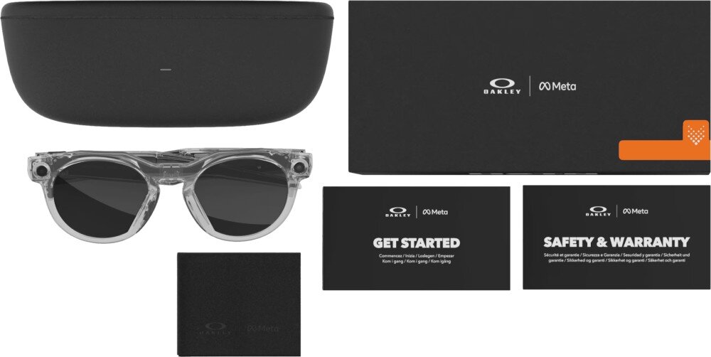 Na obrazie widoczne są przezroczyste okulary przeciwsłoneczne, czarne etui, czarna ściereczka oraz dwie karty z napisami \'GET STARTED\' i \'SAFETY & WARRANTY\'. Logo \'Oakley\' i \'Meta\' znajduje się na etui i kartach.